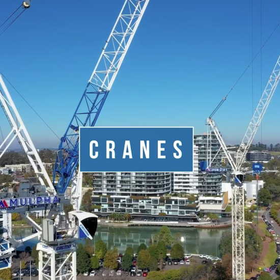 Tower cranes soar against the sky, captured in stunning detail by a drone video.